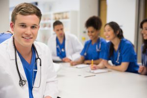 Medical student smiling at the camera during class at the university