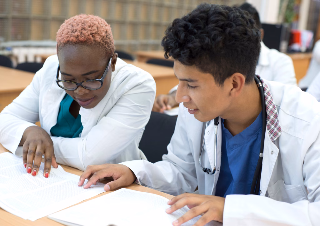 Two medicine students dicussing a case study Two medicine students dicussing a case study